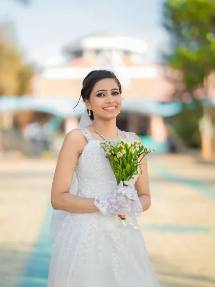 Radiant and timeless, ready to walk down the aisle. This look features a classic messy bun and minimal makeup for an elegant church wedding.