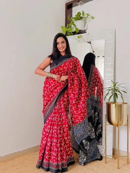 This red and black printed saree is a great option for days when you want to make a statement at work. The fabric is a comfortable art silk, perfect for all-day wear.