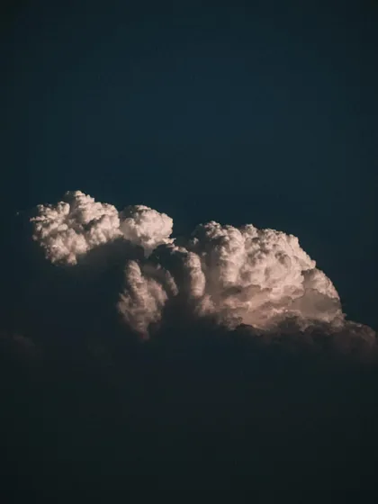 a dramatic cloud formation against a dark sky. i'm fascinated by natural textures and forms, which often inspire abstract backgrounds and visual elements in my designs.