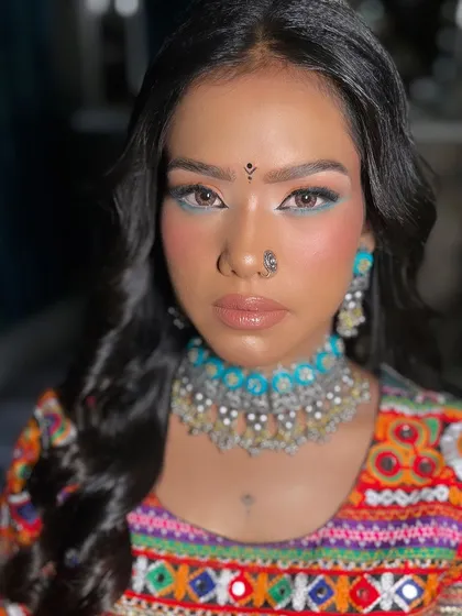 A striking close up of the Navratri makeup. The combination of a glossy nude lip and a colorful eye creates a balanced and beautiful festive look.