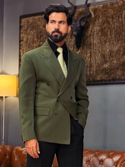 Our bottle green double-breasted blazer adds a pop of sophisticated color to any formal wardrobe. It's a versatile piece that pairs well with black trousers for an evening look.