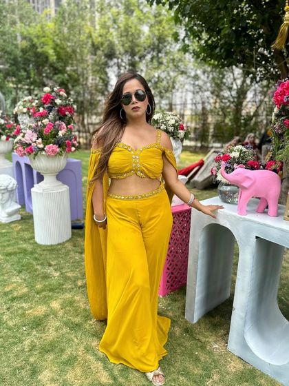 Ready to host in my sunshine-yellow attire. I always ensure my look is on point, as it's part of creating the overall visual experience for the guests.