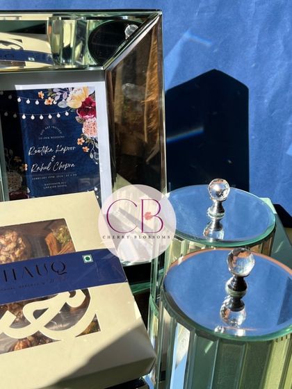 Our first wedding invitation of the season was this stunning set. It features a mirror tray, a customised frame with the invitation, glass jars with dry fruits, and a box of baklava.