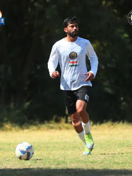 A player on the move, scanning the field for options while keeping the ball close.