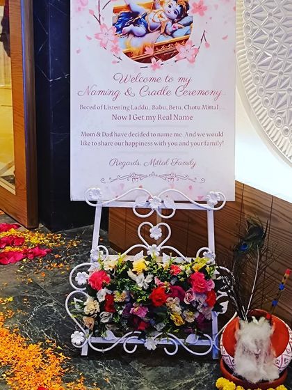 A personalized welcome sign for a naming and cradle ceremony. This elegant easel stand with flowers is a beautiful way to greet your guests.