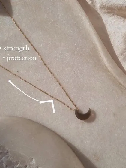 The smoky quartz Luna pendant, a stone for strength and protection. It helps to calm emotions, relieve stress, and neutralize negative vibrations.