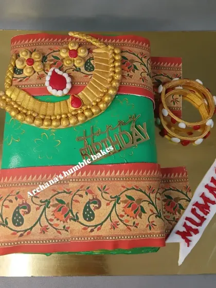 I was so happy to create this beautiful saree-themed cake for a mother's birthday. The design features an edible print of a traditional Paithani saree border and handcrafted fondant jewelry, making it a unique and personal gift.