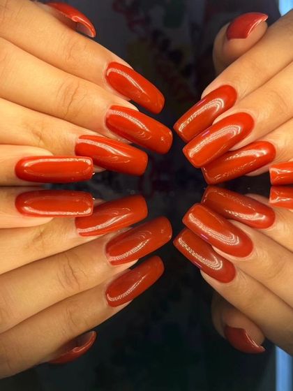 A bold and classic look with long, square-shaped nails in a vibrant, glossy red.