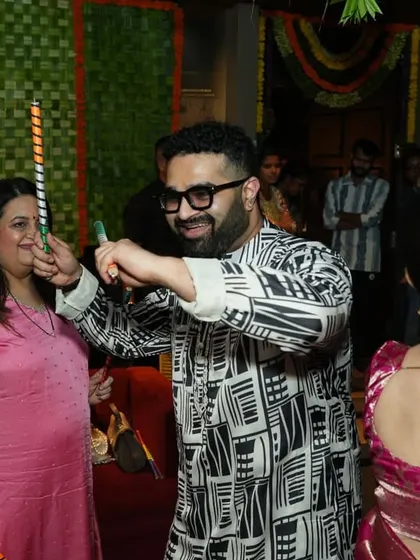 Even the guests who aren't on the main dance floor get into the spirit. Here, a guest enjoys the Dandiya music I'm playing, showing the infectious energy of the event.