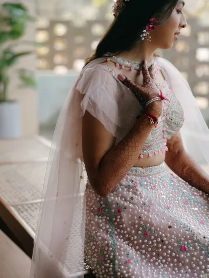 A thoughtful and serene portrait of the bride. This candid shot captures a quiet moment of reflection amidst the celebration.