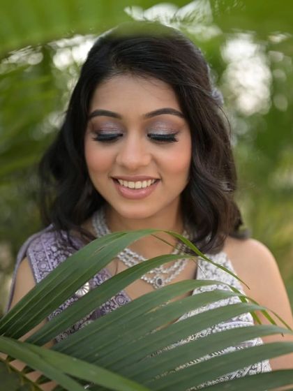 A close-up on the sparkling eye makeup. The silver and lavender tones perfectly match her outfit and create a dreamy, romantic vibe.