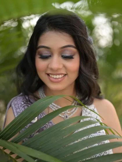 A close-up on the sparkling eye makeup. The silver and lavender tones perfectly match her outfit and create a dreamy, romantic vibe.