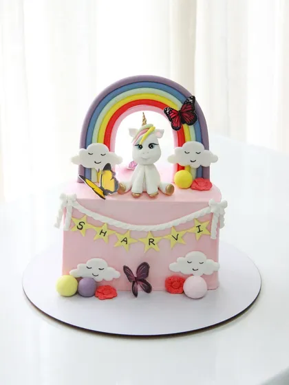 A magical unicorn and rainbow half birthday cake for Sharvi, full of color and sparkle.