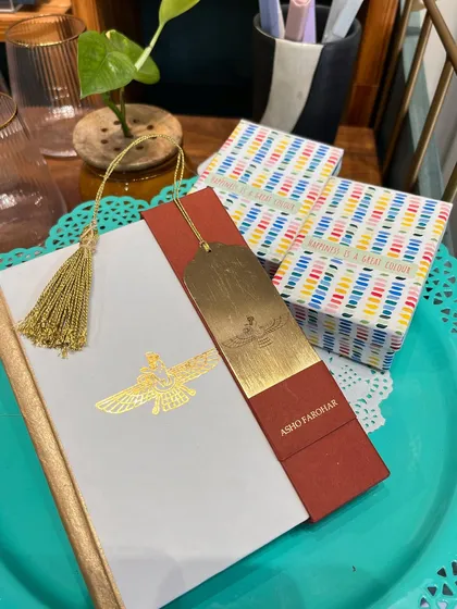 My new Asho Farohar notebook, crafted with handmade paper and a metal bookmark, is a tribute to the guardian angel within us all.