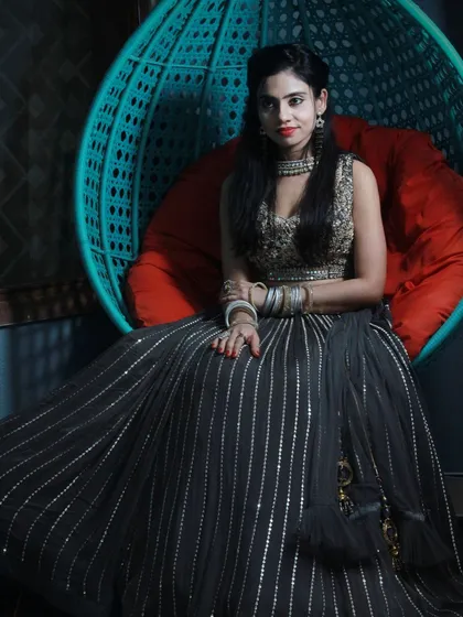 This black lehenga with vertical silver stripes and a heavily embroidered blouse is a modern and stylish option for any party.