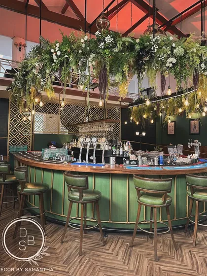 A bar isn't just a place to get a drink; it's a central social hub. We gave the Upper Deck bar a fresh, sophisticated look with a massive hanging floral installation, transforming it into a stunning focal point for the evening.