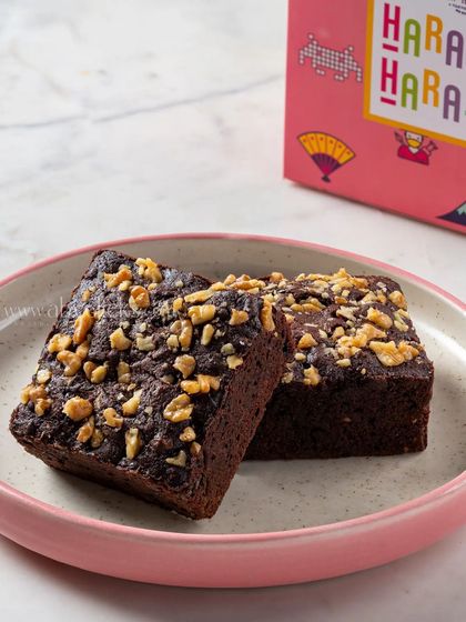 A rich walnut brownie from Harajuku Tokyo Cafe, shot up close to show its dense, fudgy texture.