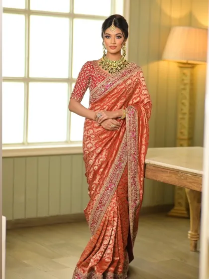 The full standing pose showcases the beautiful fall of the saree, a testament to the art of draping.