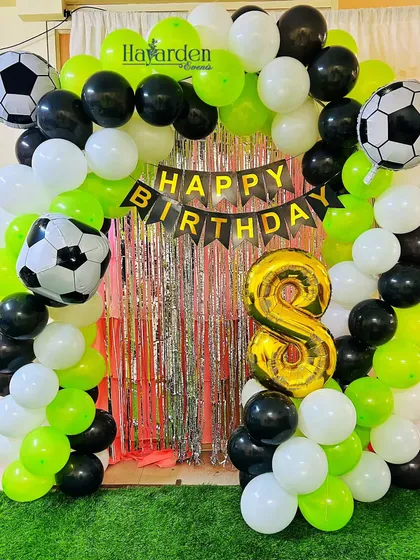 Another take on the football theme, this time with a green, black, and white color scheme and a silver fringe backdrop.