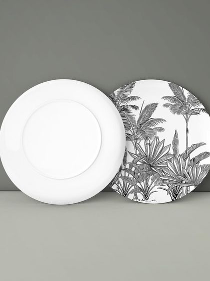 The same tropical foliage pattern applied to the back of a decorative plate. Even in simple black and white, the intricate details of the leaves create a stunning visual impact.
