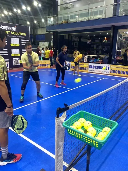 An instructor works with players on their technique. Our clinics, run in partnership with experts, focus on improving specific skills to help you get better, faster.