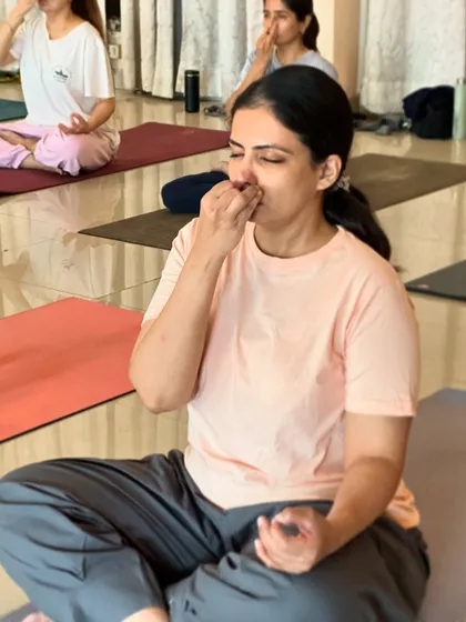 A student practices alternate nostril breathing, a technique that helps to calm the mind and prepare it for meditation.