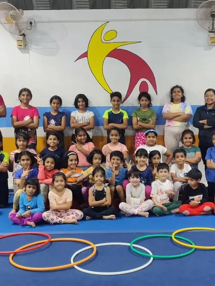 A group photo of our students and coaches with the Olympic rings made of hula hoops. A picture of our aspiring future Olympians.