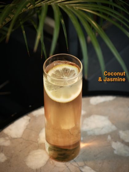 A Coconut & Jasmine cocktail, a floral and tropical creation from one of our limited-time menus. It's a light, fragrant, and elegant drink.