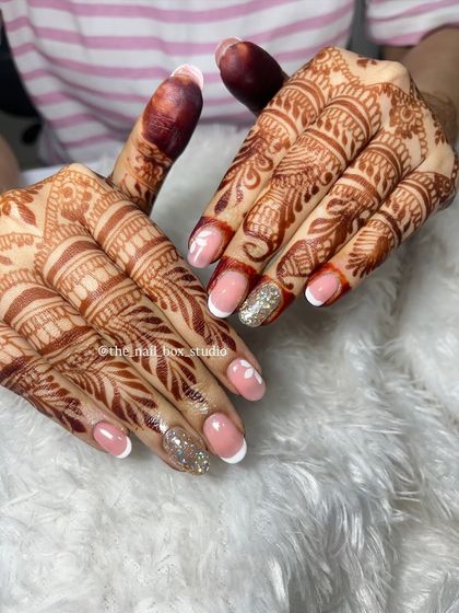 Another perspective of the soft gel extensions with French tips and floral art. This angle highlights the clean lines and the subtle elegance of the design, perfect for a bride who wants a sophisticated look.