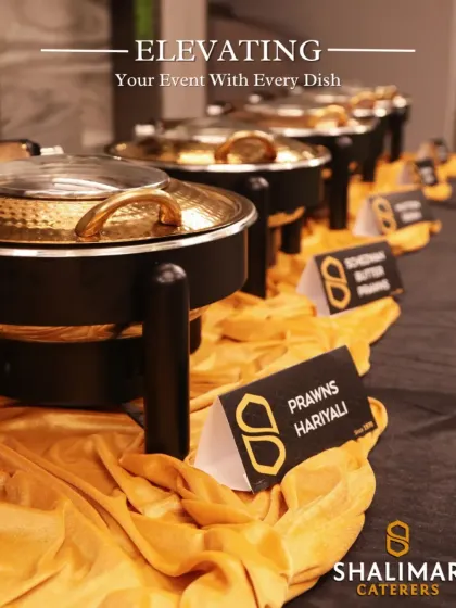 We are dedicated to elevating your event with every dish. Our buffet lines are clearly labeled and beautifully arranged, featuring dishes like Prawns Hariyali and Schezwan Butter Prawns in elegant, hammered-metal serving bowls.