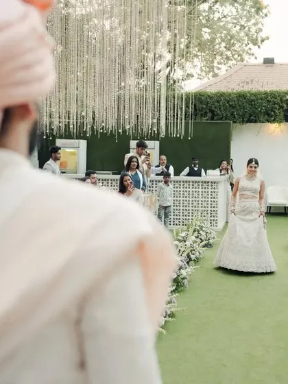 The anticipation of the first look. The groom waits as the bride makes her way down the aisle, a path I designed to be both simple and beautiful.