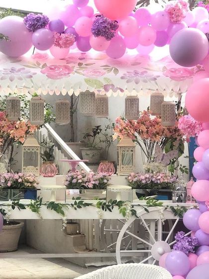 A pretty-in-pink baby shower cart decorated with a cascade of pink and purple balloons. This served as a beautiful focal point for the celebration.