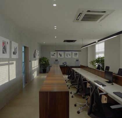 The open-plan workspace at the RS office in Chennai. I designed this area with long, continuous desks and minimalist linear lighting to maximize collaboration and focus, while large windows provide ample natural light for a productive work environment.