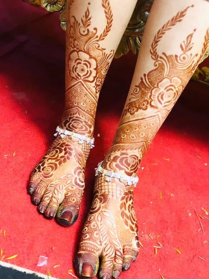 The beautiful stain of a floral foot design, showing the rich, dark color achieved with organic henna.