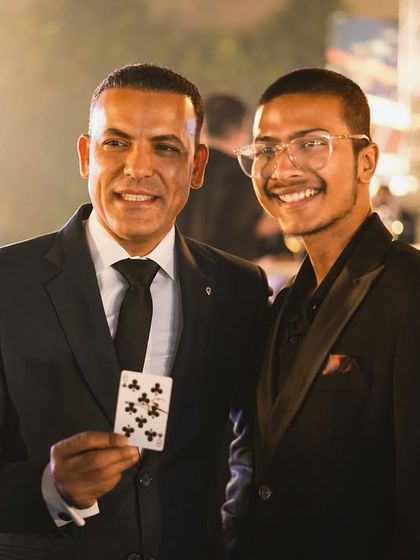 The magic is in their hands. Here, a guest holds the card that was just part of an impossible illusion, creating a tangible memory of the moment.