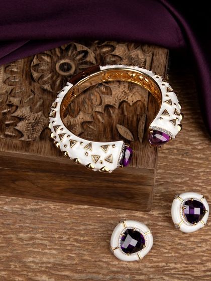 The bracelet and earrings set styled with a carved wooden box, suggesting it as a premium gift item.