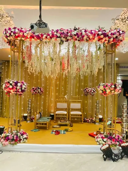 Another angle of the classic gold-framed mandap, showing the beautiful interplay of light, flowers, and shimmering fabric. This design offers a timeless and luxurious feel.