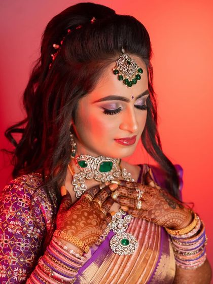 This shot highlights the stunning diamond and emerald jewellery, which was the centerpiece of her reception look. The makeup was chosen to complement these beautiful tones.