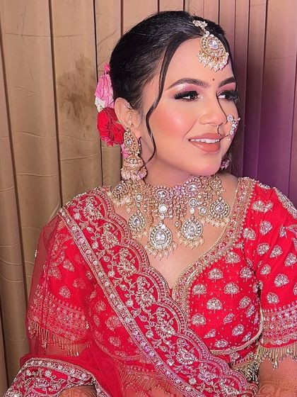 A side profile showcasing the beautiful floral bun and soft makeup. I work with my brides to choose hairstyles that not only suit their face shape but also match the vibe of their outfit and event.