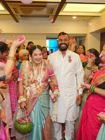 A joyous moment from a baby shower, with the couple showered in petals. She is wearing a full set of my floral jewellery and carrying a woven basket.