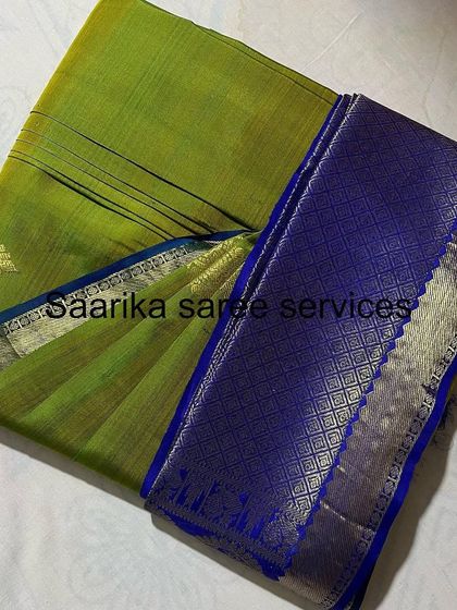 This light green saree with a royal blue border is folded to showcase its beautiful color combination.