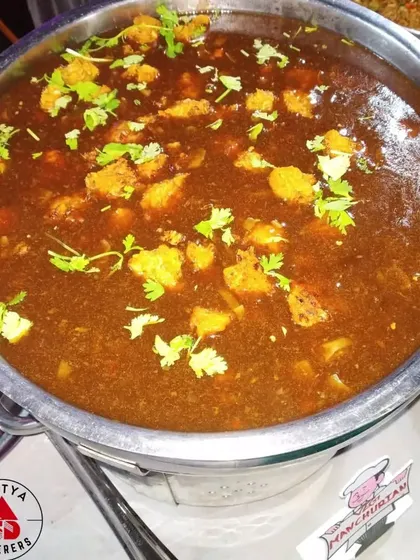 This is our signature Veg Manchurian gravy. Soft vegetable balls are simmered in a savoury and tangy soy-based sauce, garnished with fresh coriander. It's the perfect partner for fried rice or noodles.
