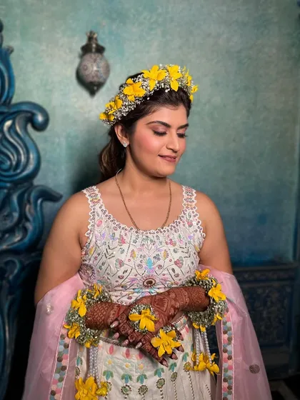 A close-up of the soft Haldi makeup. The look is all about radiant skin and a touch of color on the eyes, ensuring she looks and feels her best.