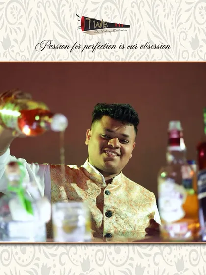 A bartender pours a classic whiskey drink, demonstrating the confident and steady hand that comes with experience and expertise.
