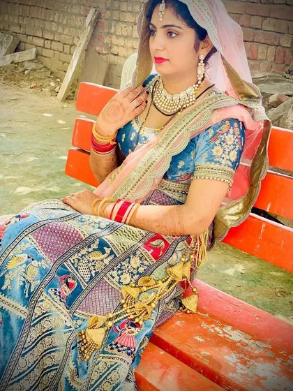 A side profile showcasing the beautiful embroidery on the blouse and the traditional latkans on this unique story-telling lehenga.
