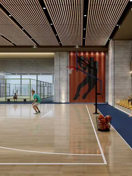 Another view of the sports club, showing the basketball court alongside a paddle tennis court. The space is designed to be a haven for sports enthusiasts, where every moment is a chance to play, connect, and thrive.