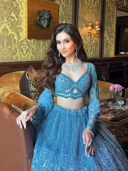 A perfect look for a sangeet or reception. This bride is glowing in a stunning blue lehenga, complemented by soft, wavy hair and diamond jewellery for a touch of modern sophistication.