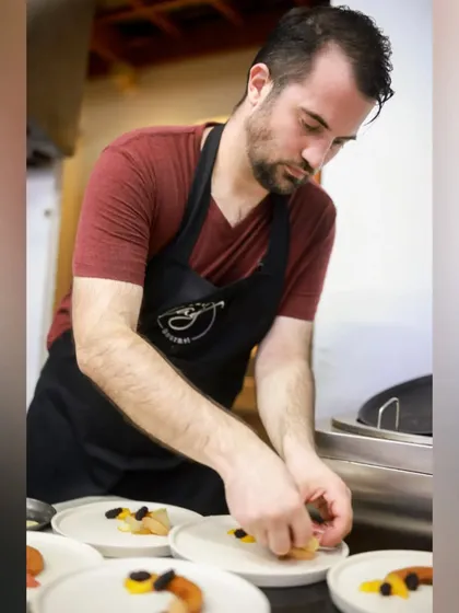 Serving culinary excellence with every bite. Here I am, carefully plating dishes for a private catering event, ensuring each one is perfect.