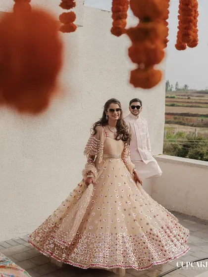 Another look at the bride's gorgeous Abhinav Mishra lehenga for the welcome lunch. The intricate mirror work and flowy silhouette make it a standout choice for a sunny, outdoor celebration.