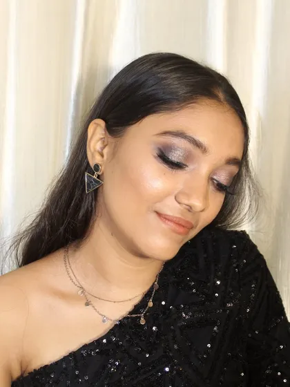 A classic smokey eye is always a perfect choice for a party. Here, I created a dark, smoldering look with a touch of glitter for extra dimension and allure.